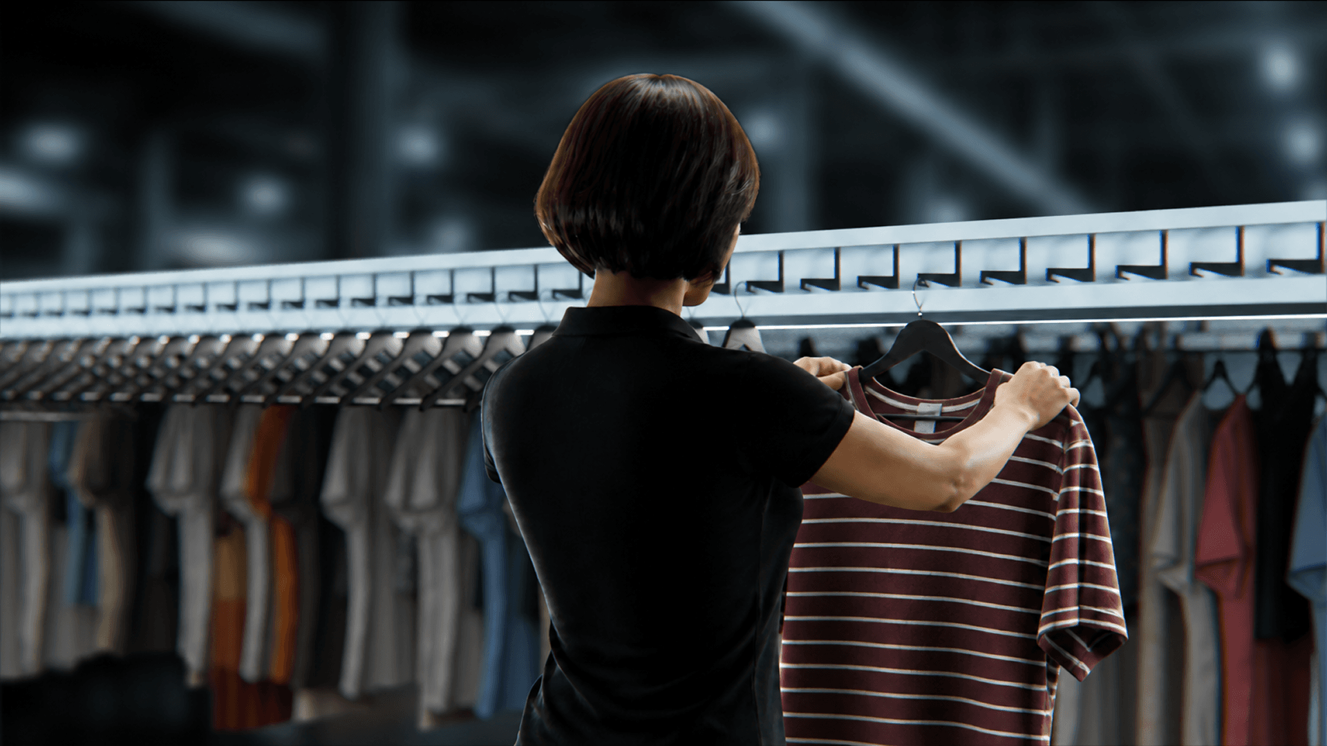 Worker sorting clothes on a rack